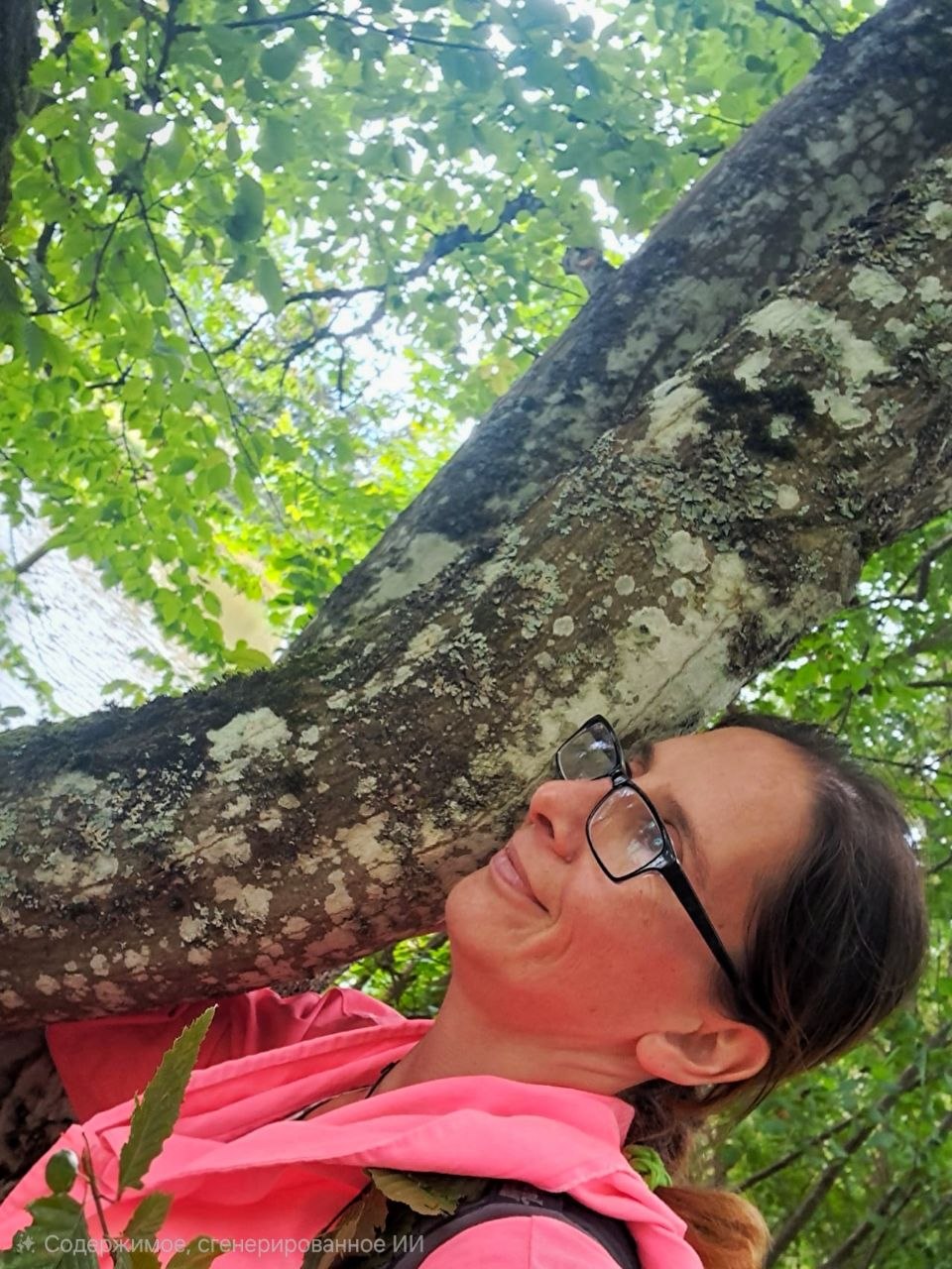 Tugba lehnt lächelnd an einem Baum